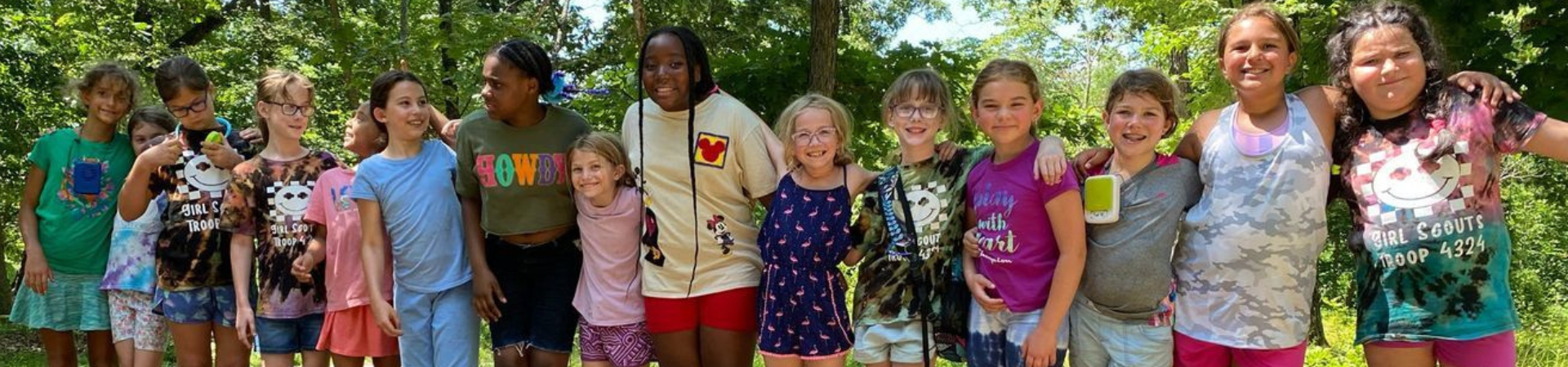  row of many girls with arms around shoulders 