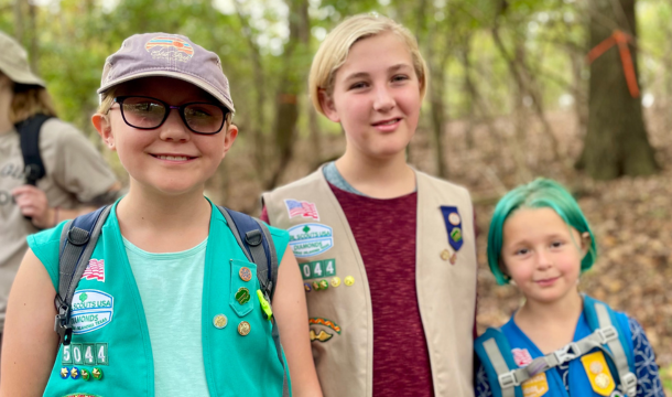 Three girls in uniform standing outside