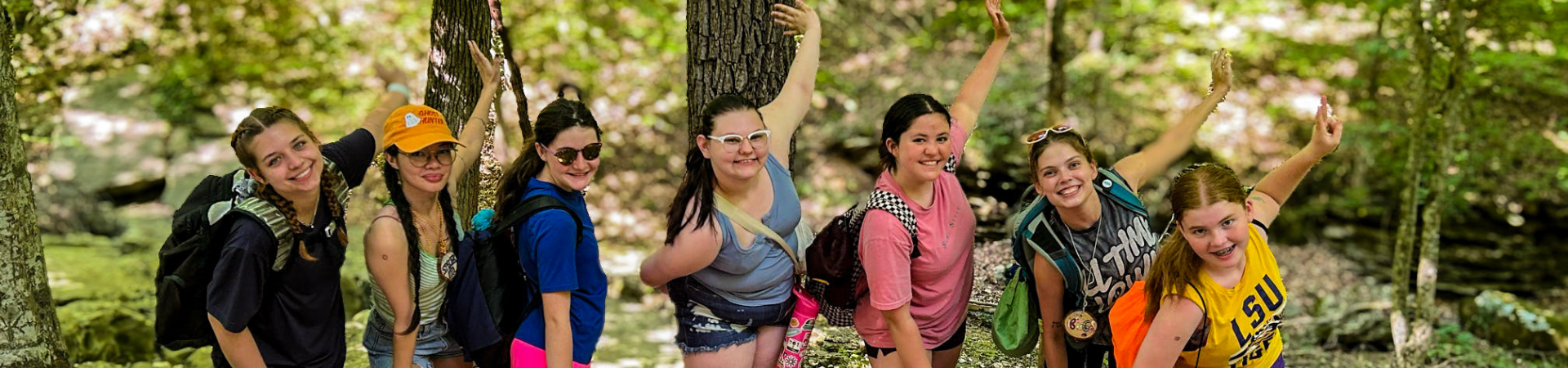  six happy girls lined up close to each other outside 