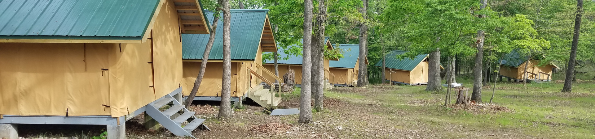  a row of platform tents at Camp NOARK girl scout property 