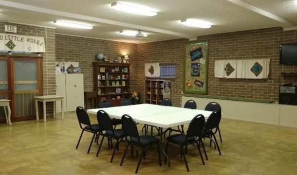 large interior space with tables and chairs at Radford House lodge girl scout property
