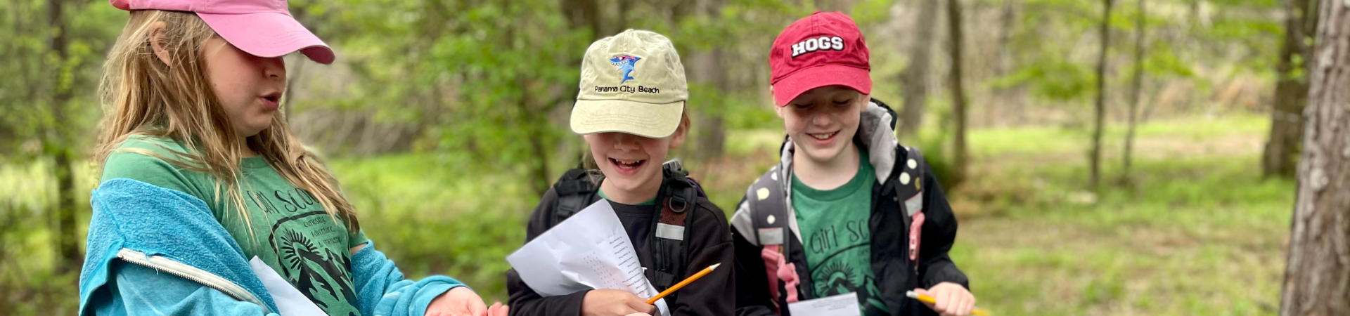  three girls take notes outside 