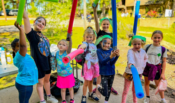 group of happy girl scouts outside having fun