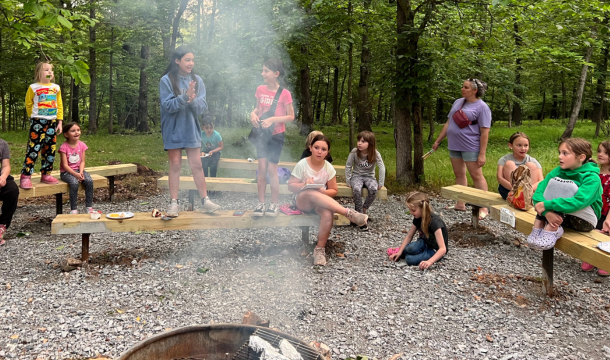 large group of girl scouts all grouped very closely and looking up at the camera