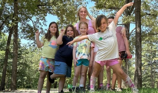 group of girl scouts posing in the outdoors