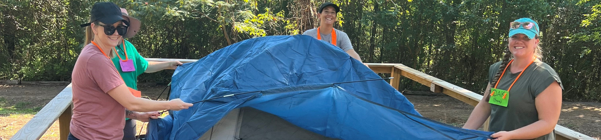  four volunteers set up a tent 