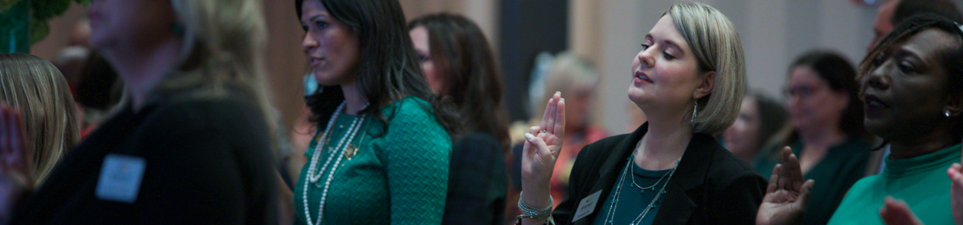  adult girl scouts recite the girl scout law at a special event 