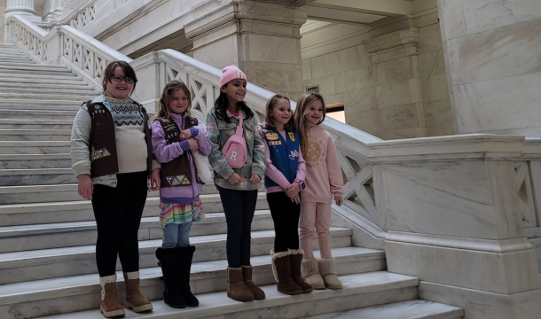 Five Girl Scouts standing on the rotunda steps inside the Arkansas State Capitol building