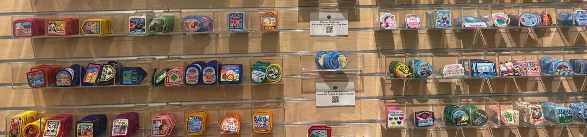  hrows of many badges in a girl scout shop 