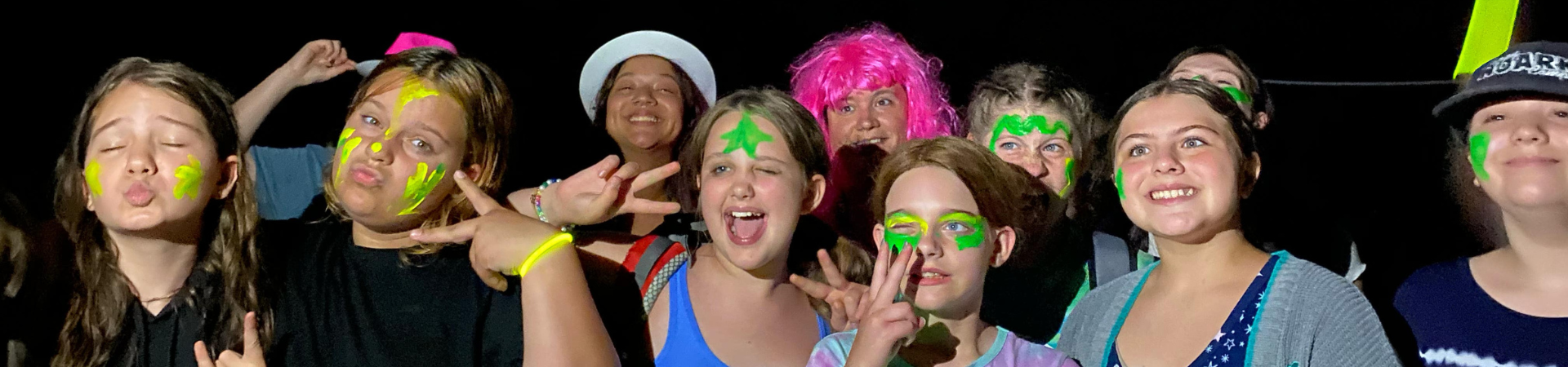  four older girls wearing neon glow in the dark items 