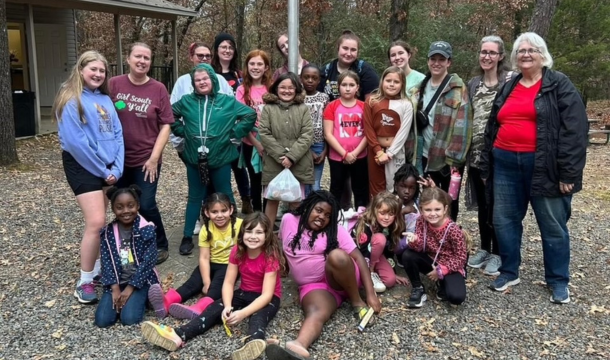 large group of Girl Scouts and Girl Scout volunteers posing in a group outdoors