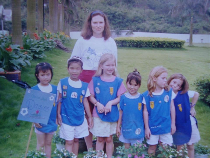 Girl Scout troop leader with a group of Daisy Girl Scouts