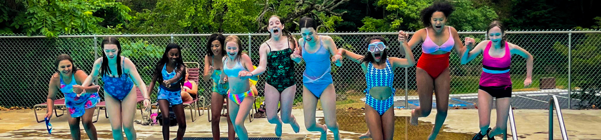  girls in swimsuits having a foam fight  